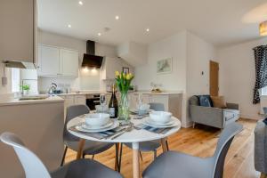 a kitchen and living room with a table and chairs at 2 Bed in Bude oc-u31759 in Bude