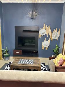 a living room with a couch and a coffee table at Ekinot homes in Lira