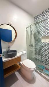 a bathroom with a toilet and a sink and a shower at Hotel Juan Dolio in Juan Dolio +74 photos