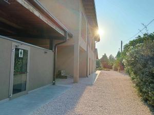 a building with the sun shining on the side of it at Agricampeggio Oro Verde in Verona