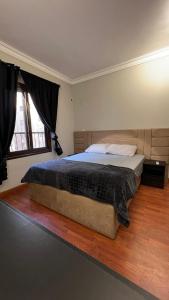 a bedroom with a large bed in a room at Tara Home 44 in Sheikh Zayed
