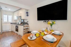 a kitchen with a wooden table with a dining room at 3 Bed in Tenby oc-m29588 in Tenby