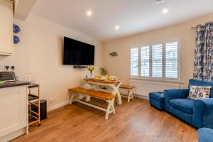 a living room with a blue couch and a table at 3 Bed in Tenby oc-m29588 in Tenby