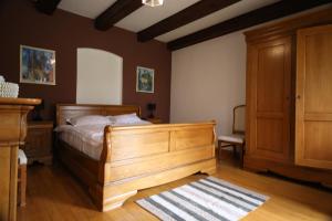 a bedroom with a wooden bed and wooden cabinets at Transylvanian Nest in Cristian