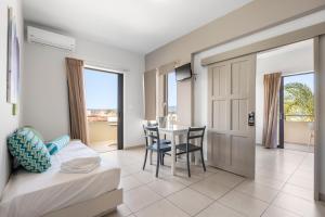 a bedroom with a bed and a table with chairs at Amaryllis in Platanias +90 photos