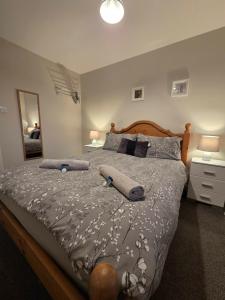 a bedroom with a bed with two pillows on it at 4b Smart Apartments in Newark-on-Trent