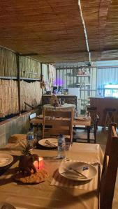 a dining room with a table and chairs and a tableablish at Petrified forest restcamp in Khorixas