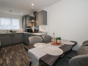 a kitchen and dining room with a table and chairs at 10 The Colliery in Telford