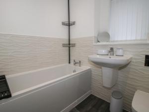 a white bathroom with a sink and a tub and a toilet at 10 The Colliery in Telford +18 photos