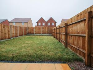 a fence in a yard with houses in the background at 10 The Colliery in Telford