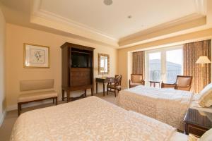 En eller flere senger på et rom på Hotel Grand Tiara Minaminagoya