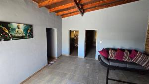 a living room with a couch and a painting on the wall at Casa 12o - Paso de la Patria in Paso de la Patria