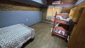 a small room with a bed and a bunk bed at Casa 12o - Paso de la Patria in Paso de la Patria +7 photos