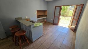 a kitchen with a counter and stools in a room at Casa 12o - Paso de la Patria in Paso de la Patria