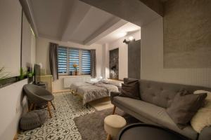 a living room with a couch and a bed at Apartmány Caffe & Grill in Roudnice nad Labem