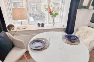 a white table in a living room with a window at Central 1BR Studio - Walk Everywhere in Aarhus in Aarhus