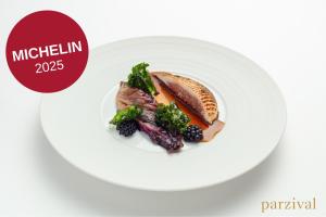 a plate of food with meat and vegetables on it at Hotel BOOKQUET in Prague