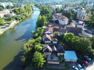 an aerial view of a house next to a river at Riverside Panorama Apartment 1 near City Center Brko 1 in Banja Luka