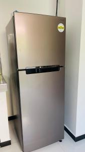 a stainless steel refrigerator with a sticker on it at Isuru villa in Matara
