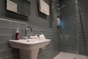 a bathroom with a sink and a shower at Keons Town House in Longford