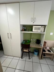 a small kitchen with a table and a microwave at Hotel em Barreirinhas in Barreirinhas