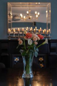 a vase filled with flowers sitting on a table at Keons Town House in Longford +12 photos