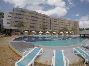a large swimming pool with chairs and a hotel at Hotel em Barreirinhas in Barreirinhas
