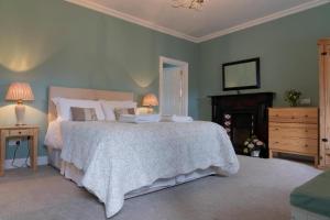 a bedroom with a bed and a dresser and a television at Keons Town House in Longford