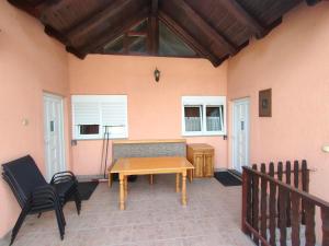 a patio with a wooden table and two chairs at Riverside Panorama Apartment 1 near City Center Brko 1 in Banja Luka