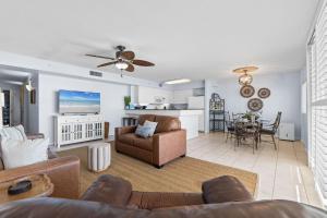 a living room with a couch and a table at Dune Pointe 402 - Shells, Surf & Sea Turtles in Fort Walton Beach