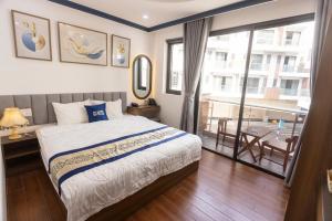 a bedroom with a bed and a balcony at Gu Boutique Hotel - Central Phan Rang in Phan Rang–Tháp Chàm +16 photos