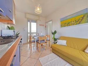 a kitchen and living room with a couch and a table at Villetta Tina Private Pool - Torre Pali in Torre Pali