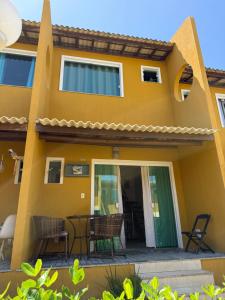 a house with a patio in front of it at Casa summer flats 23 Imbassai in Imbassai