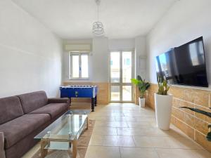 a living room with a couch and a pool table at Villetta Tina Private Pool - Torre Pali in Torre Pali
