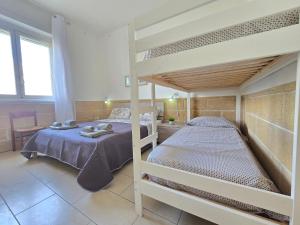 a bedroom with two bunk beds in a room at Villetta Tina Private Pool - Torre Pali in Torre Pali +30 photos