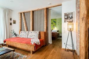 a living room with a couch and a bedroom at Modernes Apartment OLIVE Stilvoll und zentral in Besigheim in Besigheim