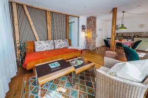 a living room with a bed and a table at Modernes Apartment OLIVE Stilvoll und zentral in Besigheim in Besigheim +26 photos