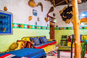 a room with a couch and chairs in a room at Traditional Berber Eco Farm Stay in Agadir