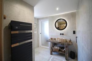 a bathroom with a mirror and a wooden table at Kernad in Bersac-sur-Rivalier +47 photos