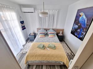 a small bedroom with a large bed with two pillows at Triumph 1 - A in Paralimni
