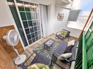 a living room with a couch and chairs and a fan at Triumph 1 - A in Paralimni