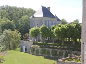an old house with a garden in front of it at Château d'Hodebert in Saint-Paterne-Racan