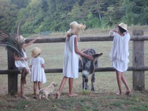 a group of girls standing around a fence with a goat at Château d'Hodebert in Saint-Paterne-Racan +82 photos