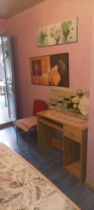 a room with a desk and a table and a chair at Chez NONO in Ruffec