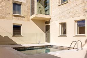 a house with a swimming pool next to a building at CASA ioio in Jaunay-Clan