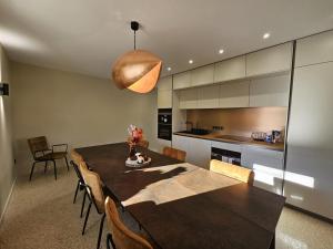 a kitchen and dining room with a table and chairs at CASA ioio in Jaunay-Clan