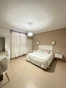 a bedroom with a bed and a tv in it at Hotel Castillo de Montemayor in Montemayor +4 photos
