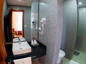 a bathroom with a sink and a shower with a phone at Hotel Boutique Circasiana Palace in Quito +37 photos