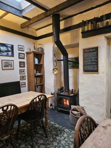 a dining room with a table and a wood stove at The Rockford Inn in Lynton