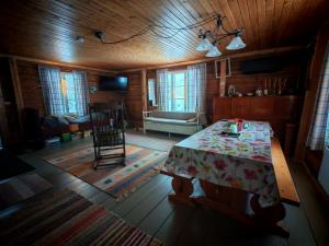 a living room with a table and a couch at Savupirtti 1819 in Pudasjärvi